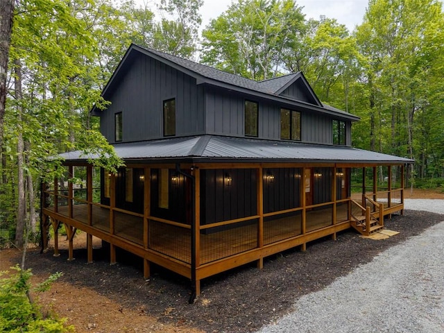 365 Cherokee Cir, Lake Toxaway, NC 28747 - rear view of property featuring board and batten siding, a shingled roof, and a metal roof
