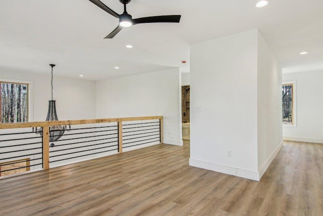 empty room featuring light wood-style floors, recessed lighting, ceiling fan, and baseboards