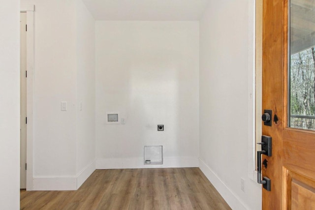 clothes washing area featuring laundry area, washer hookup, wood finished floors, baseboards, and electric dryer hookup