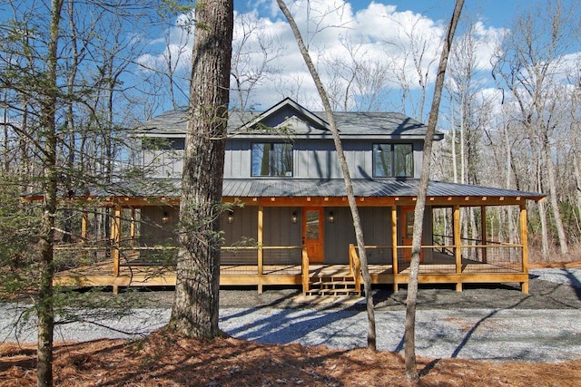 view of front facade featuring a deck and metal roof