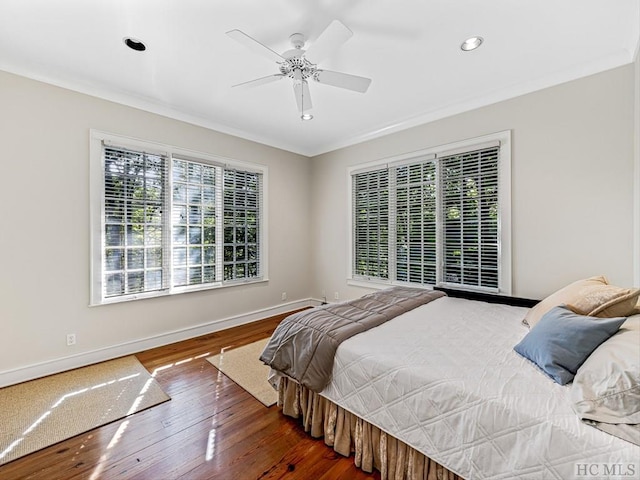 bedroom featuring ornamental molding, dark hardwood / wood-style floors, and ceiling fan