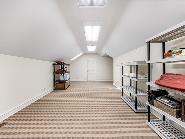 bonus room with vaulted ceiling and light colored carpet