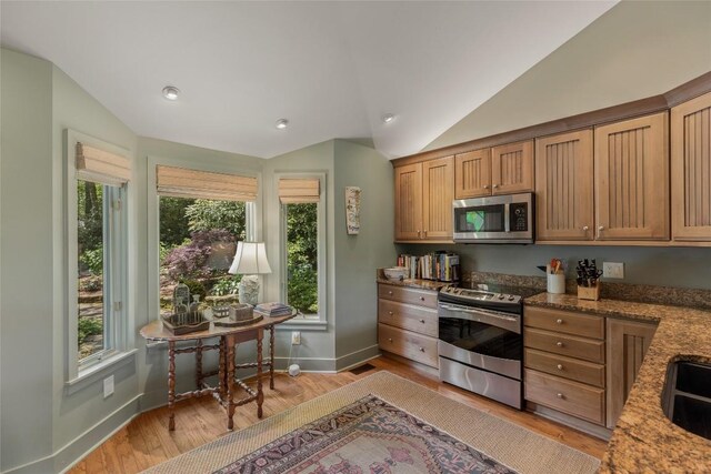 72 Winterberry Ct Unit 7, Highlands, NC 28741 - kitchen with appliances with stainless steel finishes, vaulted ceiling, plenty of natural light, light wood finished floors, and light stone countertops