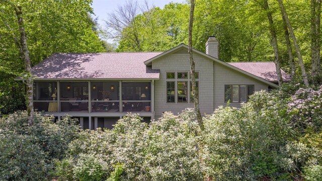 72 Winterberry Ct Unit 7, Highlands, NC 28741 - back of house with a sunroom, a chimney, and a shingled roof
