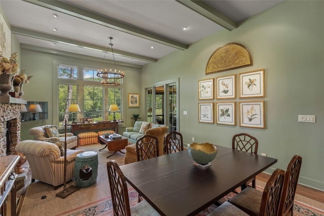 72 Winterberry Ct Unit 7, Highlands, NC 28741 - dining room with beamed ceiling, a fireplace, and a chandelier