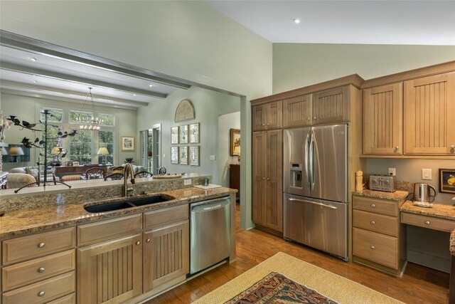 72 Winterberry Ct Unit 7, Highlands, NC 28741 - kitchen with stainless steel appliances, lofted ceiling, light wood finished floors, light stone counters, and pendant lighting