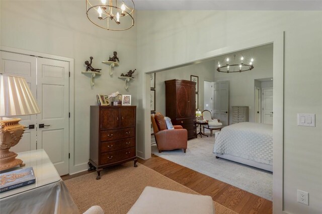 72 Winterberry Ct Unit 7, Highlands, NC 28741 - bedroom featuring a chandelier, wood finished floors, and a towering ceiling