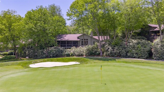 72 Winterberry Ct Unit 7, Highlands, NC 28741 - view of community featuring an area to practice putting, view of golf course, a yard, and view of scattered trees