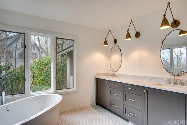 bathroom featuring tile patterned flooring, vanity, and a washtub