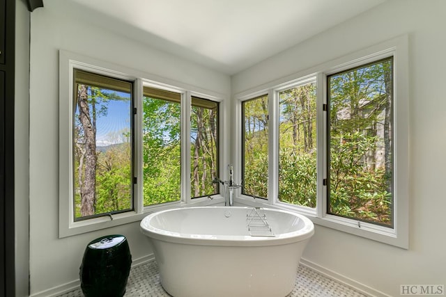 bathroom with tile patterned flooring and a bathing tub