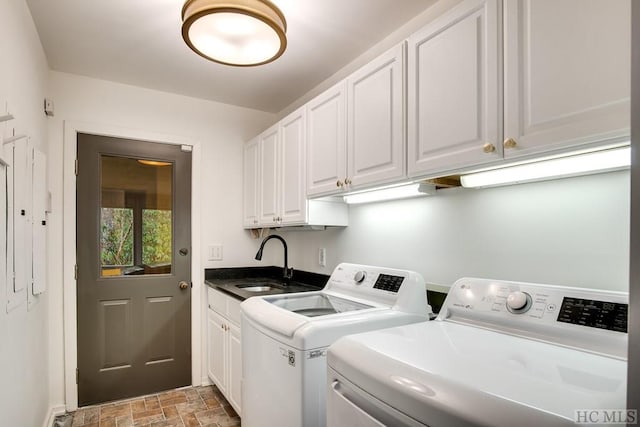 laundry room featuring cabinets, sink, and washer and dryer