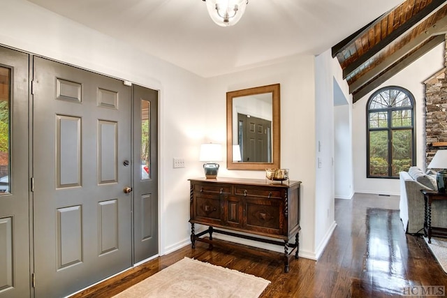 foyer featuring lofted ceiling and dark hardwood / wood-style flooring