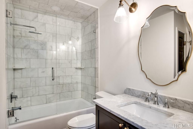 full bathroom with vanity, toilet, and combined bath / shower with glass door