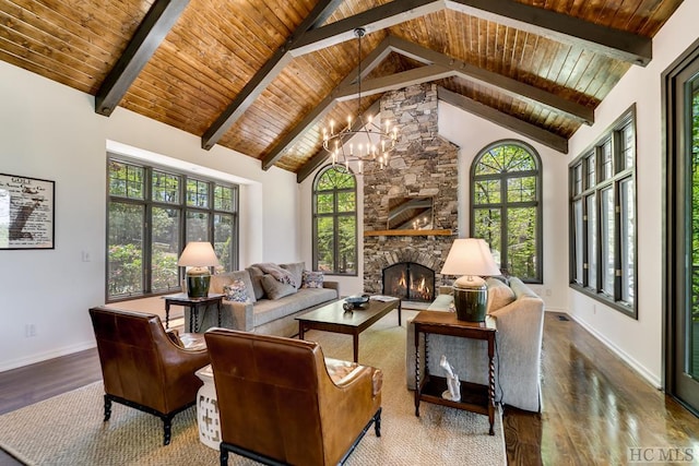 interior space with wood ceiling, vaulted ceiling with beams, a stone fireplace, and a notable chandelier