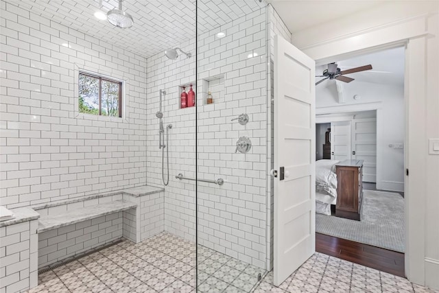 ensuite bathroom with tiled shower and ceiling fan