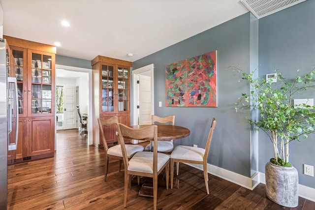 dining area with dark wood-style flooring, recessed lighting, and baseboards
