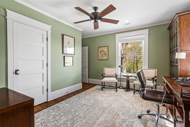 home office featuring ornamental molding, baseboards, wood finished floors, and ceiling fan