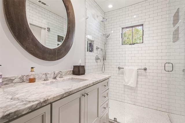 full bathroom featuring a shower stall and vanity