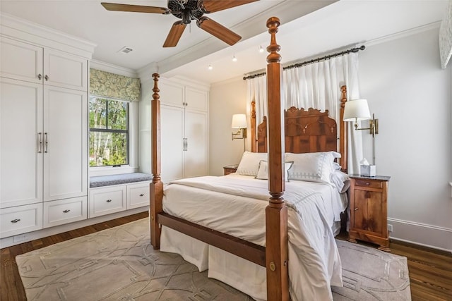 bedroom with ornamental molding, wood finished floors, and ceiling fan