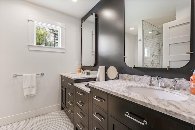 full bath featuring a tile shower, baseboards, vanity, and recessed lighting
