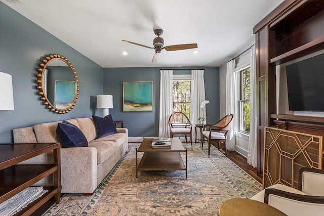 living room with ceiling fan, recessed lighting, baseboards, and wood finished floors