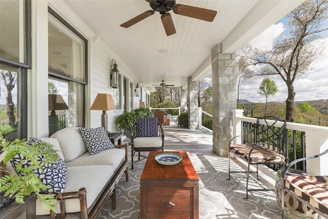 sunroom / solarium featuring a ceiling fan and an outdoor living space