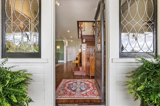 foyer with stairway, ornamental molding, dark wood-style floors, and recessed lighting
