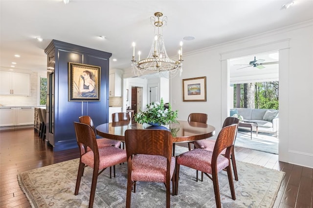 dining space with dark wood-type flooring, a chandelier, crown molding, and recessed lighting
