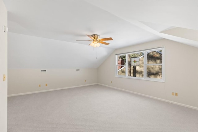 bonus room featuring ceiling fan, lofted ceiling, and light carpet