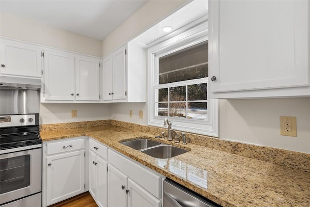 kitchen featuring sink, white cabinetry, stainless steel appliances, light stone counters, and ventilation hood