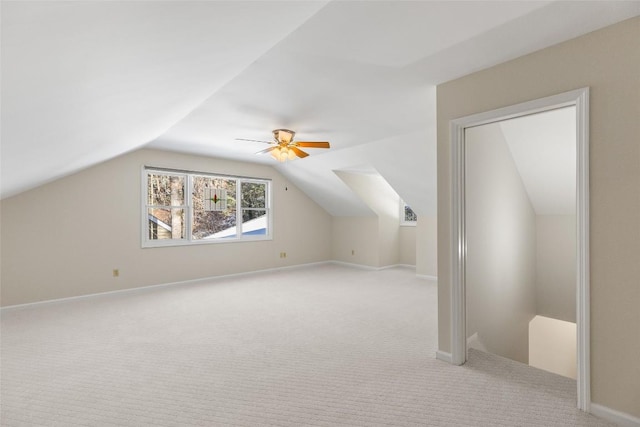 additional living space featuring ceiling fan, light colored carpet, and lofted ceiling