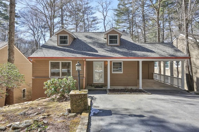 cape cod house featuring a carport