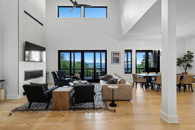 55 Steeplebush Ct, Tuckasegee, NC 28783 - living area featuring a high ceiling, light wood-style floors, and a fireplace