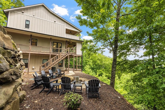 55 Steeplebush Ct, Tuckasegee, NC 28783 - back of house with board and batten siding, stairs, and a fire pit