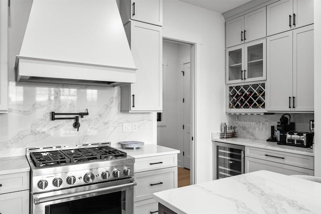 55 Steeplebush Ct, Tuckasegee, NC 28783 - kitchen featuring high end stainless steel range oven, beverage cooler, custom exhaust hood, tasteful backsplash, and glass insert cabinets