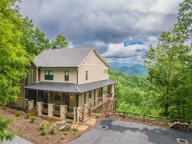 55 Steeplebush Ct, Tuckasegee, NC 28783 - view of front facade featuring a porch, a standing seam roof, a shingled roof, a metal roof, and a mountain view