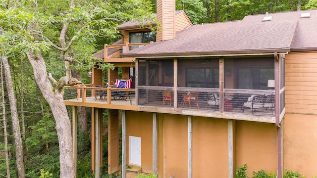 230 Jersey Trl Unit 12, Sapphire, NC 28774 - back of house featuring a chimney, roof with shingles, a balcony, and a sunroom