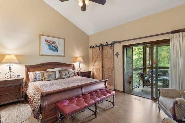 230 Jersey Trl Unit 12, Sapphire, NC 28774 - bedroom with access to exterior, wood finished floors, a barn door, a ceiling fan, and high vaulted ceiling