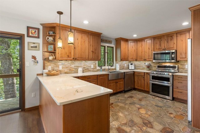 230 Jersey Trl Unit 12, Sapphire, NC 28774 - kitchen with stainless steel appliances, a peninsula, healthy amount of natural light, brown cabinetry, and recessed lighting