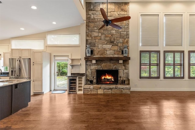 314 Beckonridge Trl, Sapphire, NC 28774 - unfurnished living room with ceiling fan, wine cooler, wood finished floors, a stone fireplace, and high vaulted ceiling