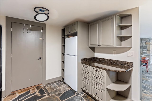 314 Beckonridge Trl, Sapphire, NC 28774 - kitchen with open shelves, dark stone finish flooring, freestanding refrigerator, dark stone countertops, and gray cabinets