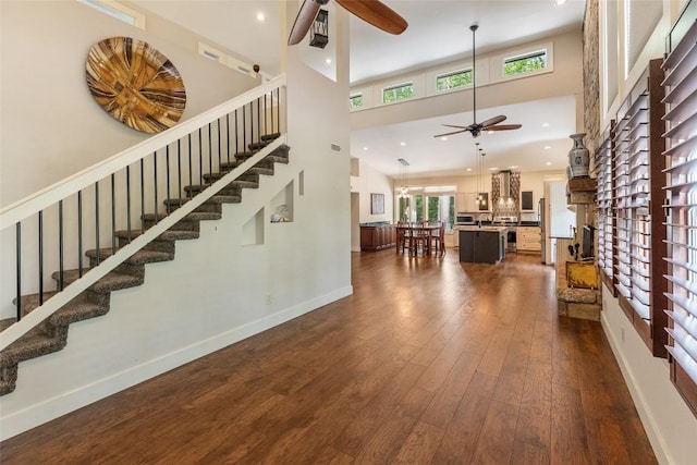 314 Beckonridge Trl, Sapphire, NC 28774 - living room featuring ceiling fan, plenty of natural light, stairway, a high ceiling, and dark wood-style flooring