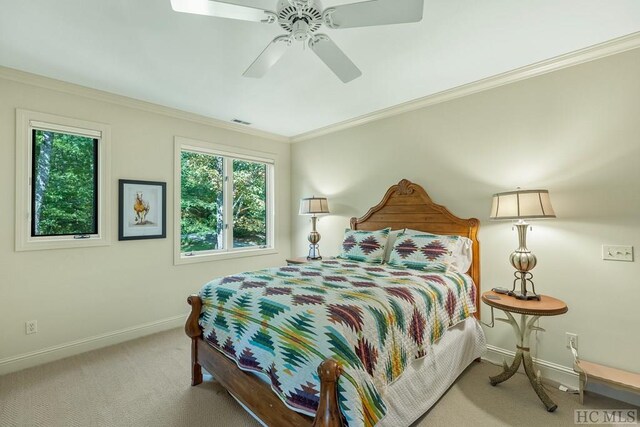 bedroom with ceiling fan, ornamental molding, and light colored carpet