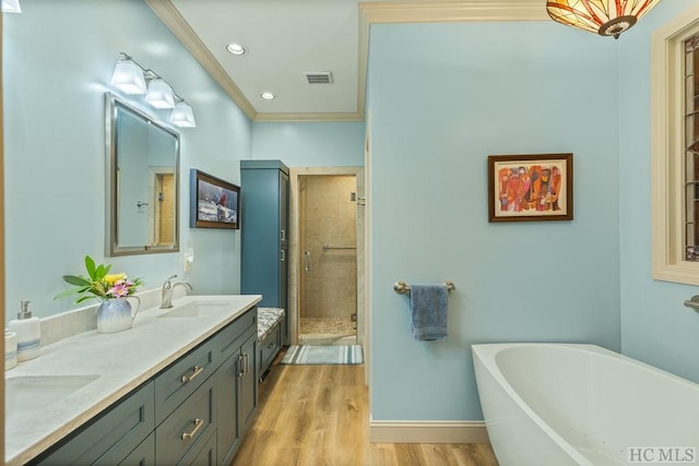 bathroom with crown molding, vanity, independent shower and bath, and hardwood / wood-style floors