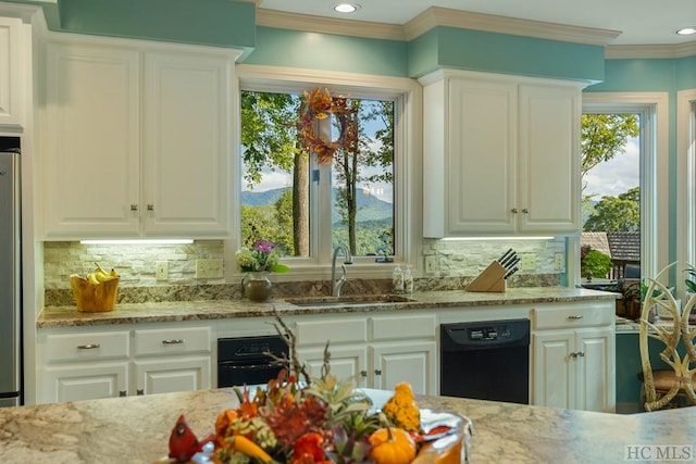 kitchen featuring dishwasher, a mountain view, sink, and backsplash