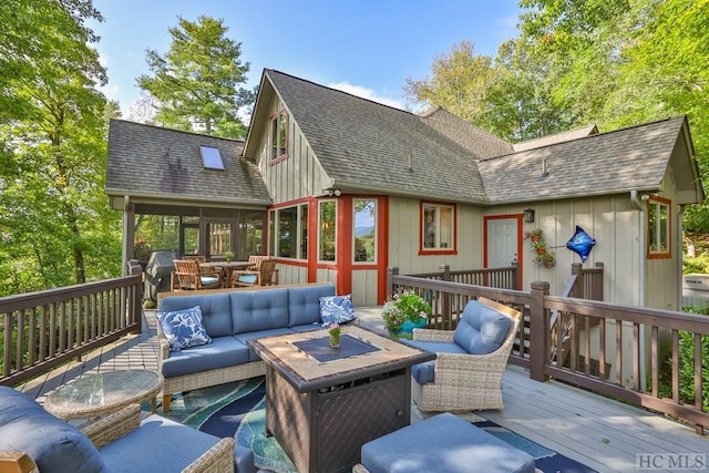 wooden deck featuring a sunroom and an outdoor hangout area