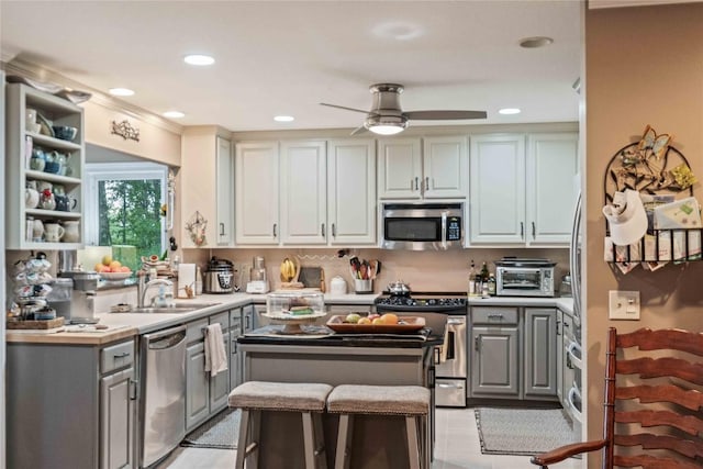 546 Upsy Daisy Ln, Cullowhee, NC 28723 - kitchen featuring appliances with stainless steel finishes, gray cabinets, a center island, light countertops, and ceiling fan
