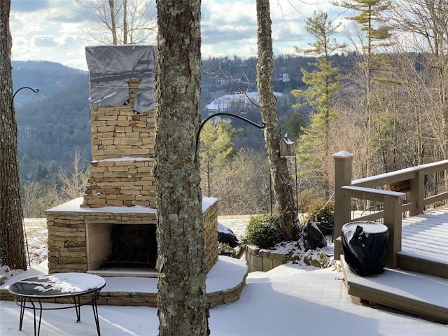 546 Upsy Daisy Ln, Cullowhee, NC 28723 - view of patio with an outdoor stone fireplace, a forest view, and a deck