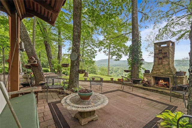 546 Upsy Daisy Ln, Cullowhee, NC 28723 - view of patio with an outdoor stone fireplace and a mountain view