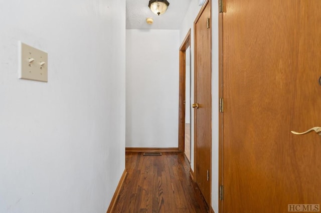 corridor featuring dark wood-type flooring